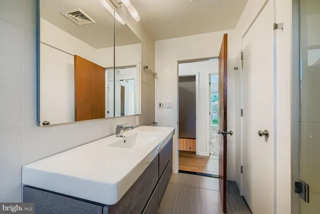 a bathroom with a sink a mirror and a shower
