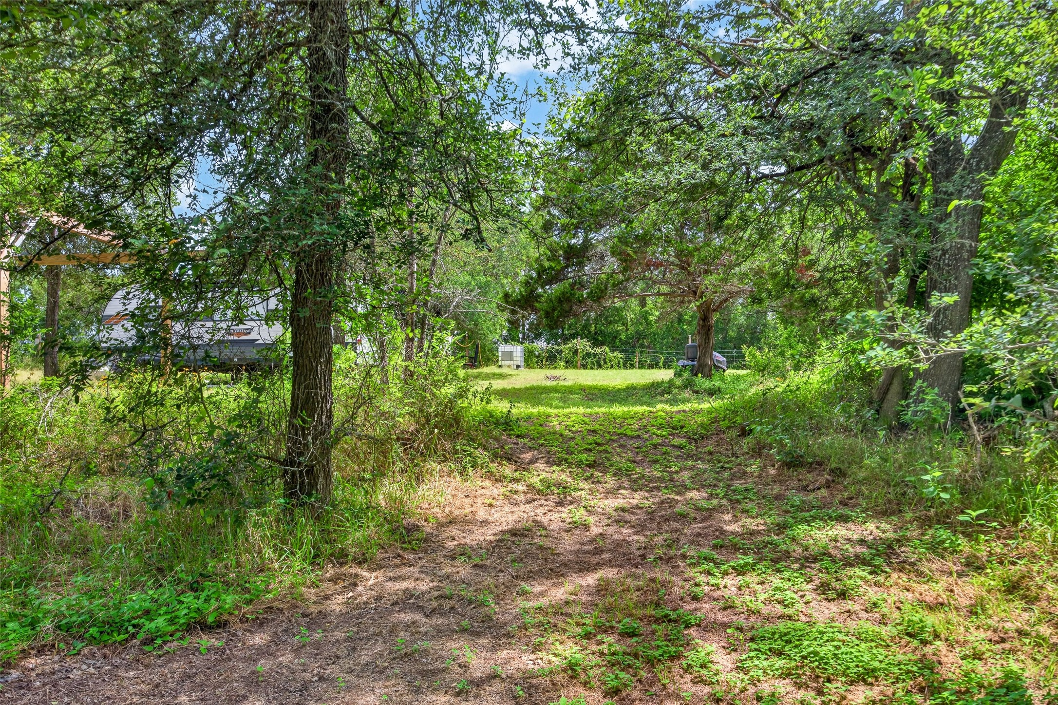 266 Beaver Road Elgin, TX 78621 - Photo 21 of 40 A tranquil, tree-lined yard offers a peaceful natural setting.