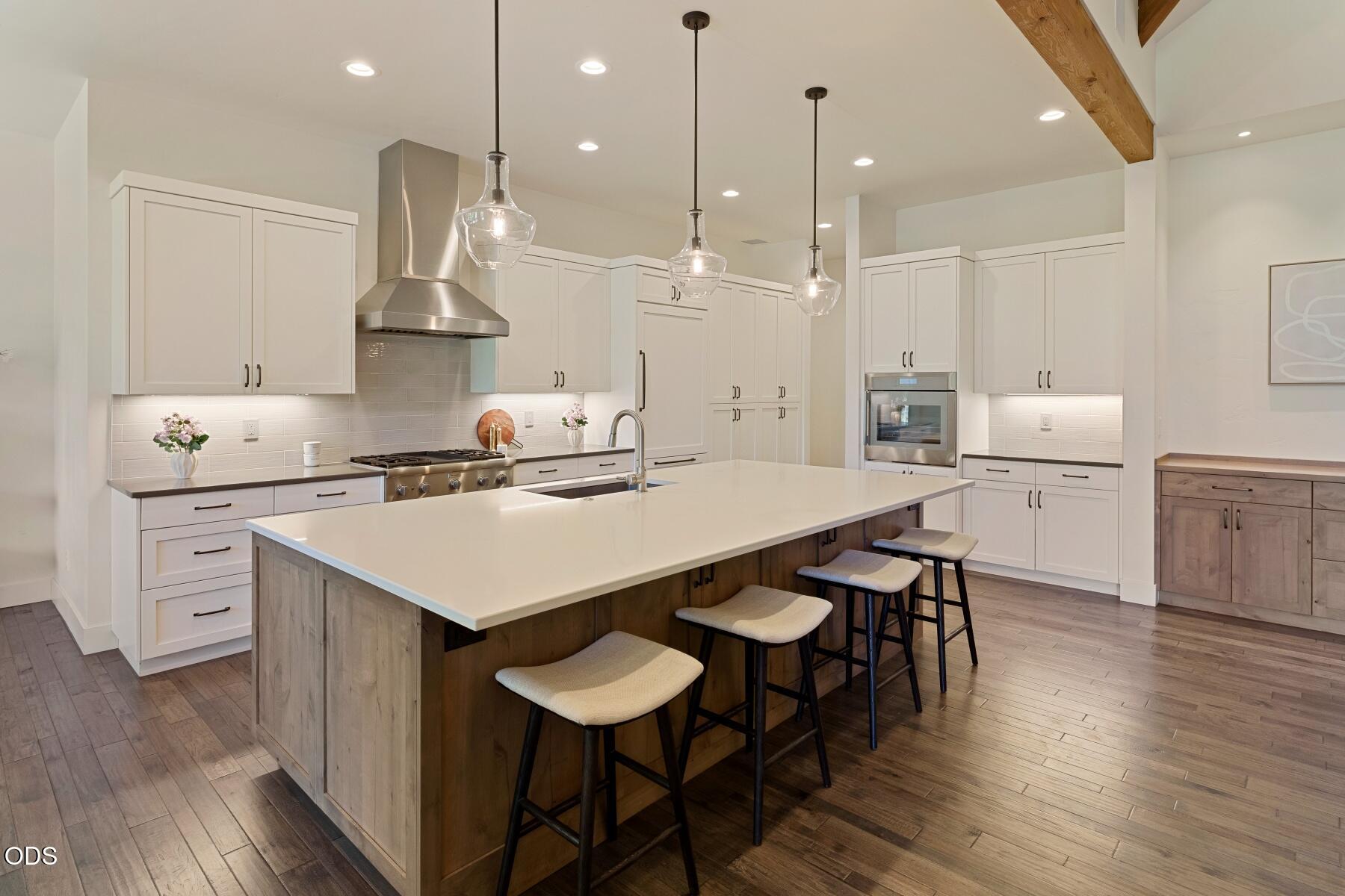60255 Sunset View Drive Bend, OR 97702 - Photo 12 of 48 a kitchen with a table chairs stove and wooden floor