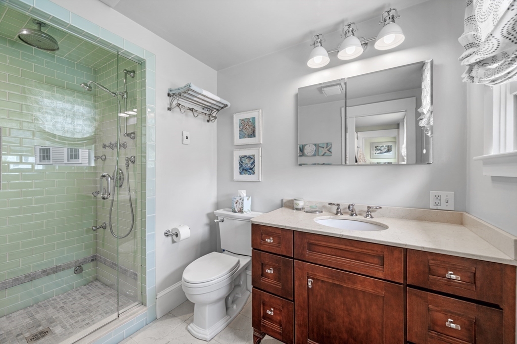 5 Gregory Street Marblehead, MA 01945 - Photo 16 of 29 a bathroom with a toilet a sink and shower