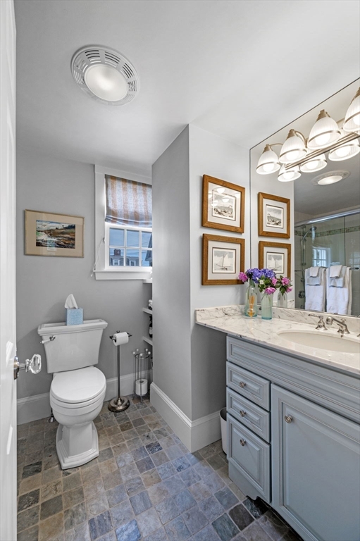 5 Gregory Street Marblehead, MA 01945 - Photo 18 of 29 a bathroom with a toilet sink and mirror