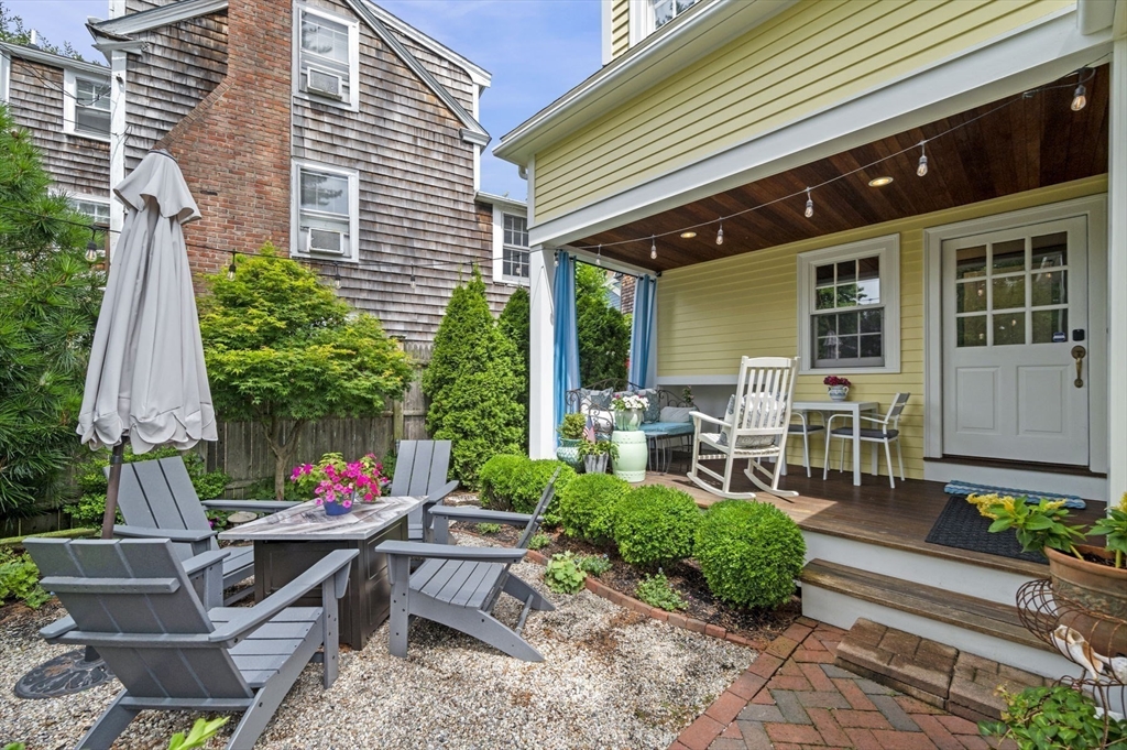 5 Gregory Street Marblehead, MA 01945 - Photo 24 of 29 a view of backyard with table and chairs and potted plants