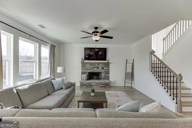 a living room with furniture a fireplace and a chandelier