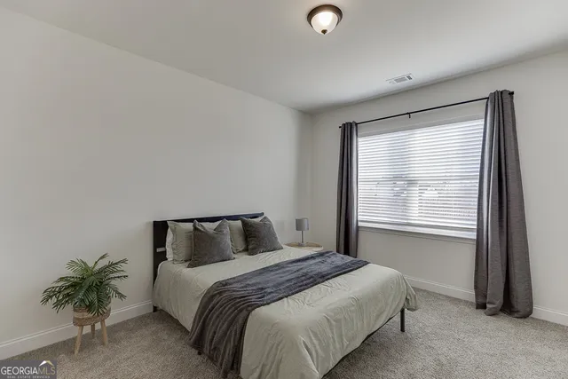 a bedroom with a bed and a closet