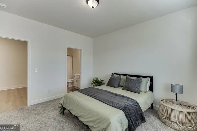 a bathroom with a sink toilet and a mirror