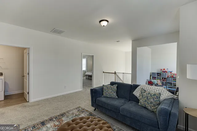 a view of room with furniture and windows