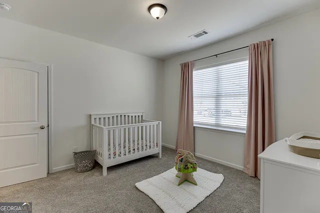 a bedroom with a bed and a lamp