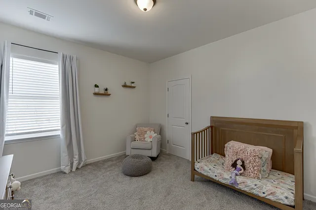 a spacious bedroom with a bed and a ceiling fan