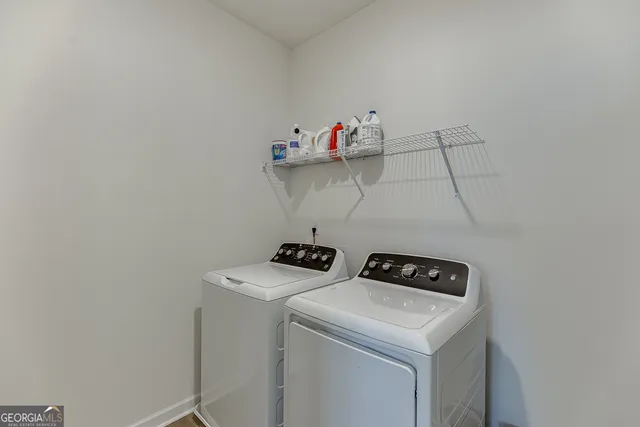 a view of walk in closet with clothes