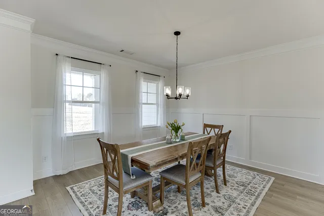 a view of a dining room with furniture window and wooden floor