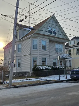 a front view of a house with a street