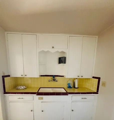 a kitchen with a sink and cabinets