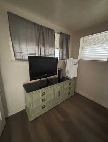a room with furniture and flat screen tv