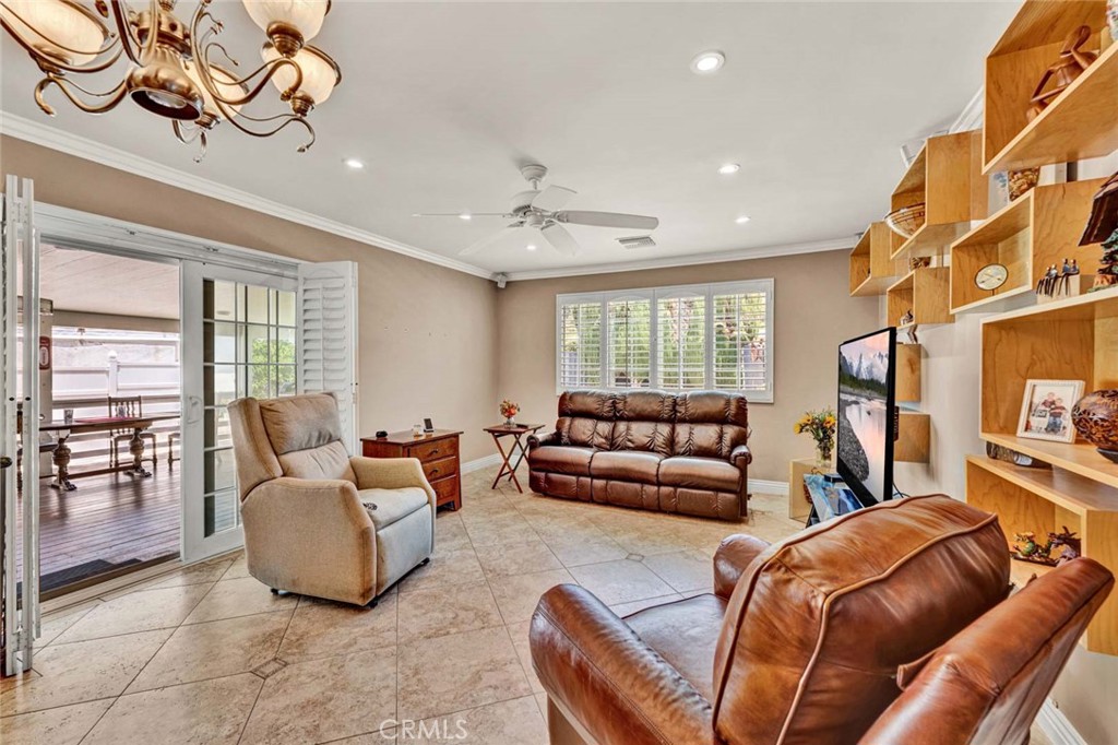 5456 Cadbury Road Whittier, CA 90601 - Photo 11 of 67 a living room with furniture a ceiling fan and a window