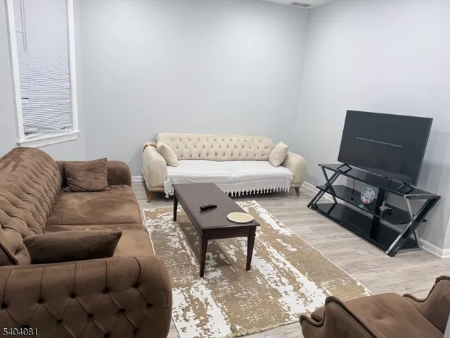 a living room with furniture and a rug