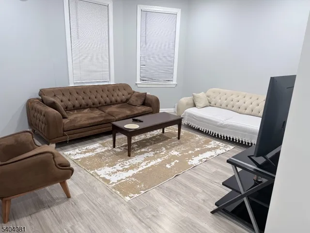 a living room with furniture and a rug