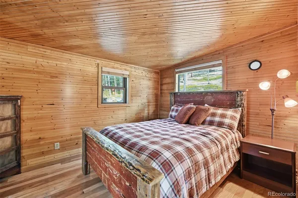a bed sitting in a bedroom next to a window