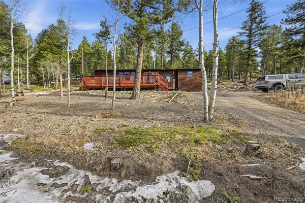 a view of a backyard with wooden fence