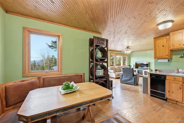 a view of a dining room with furniture a kitchen and chandelier