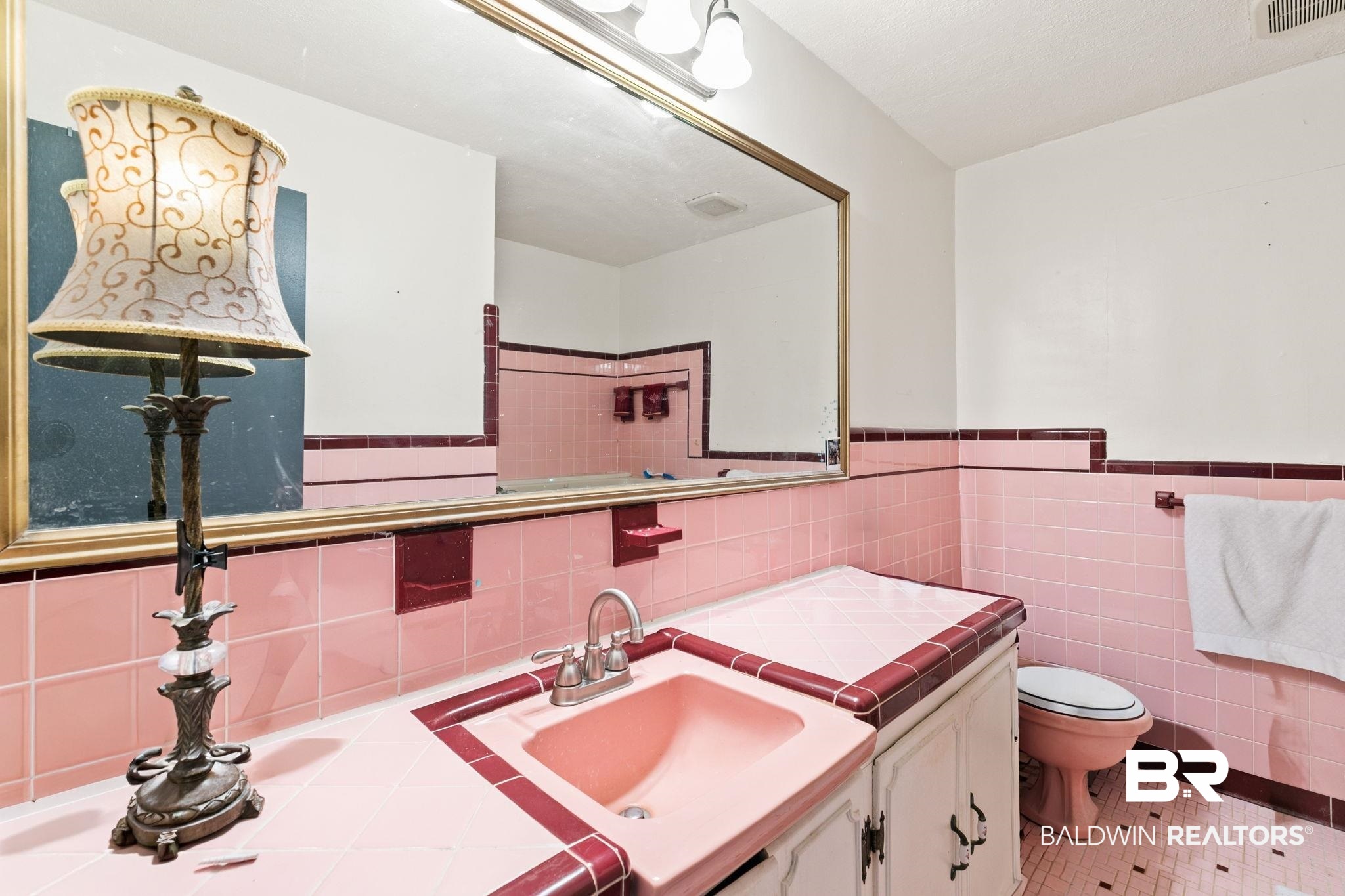 927 Cleveland Road Saraland, AL 36571 - Photo 28 of 80 Bathroom featuring pink tiled walls and contrasting dark red accent tiles