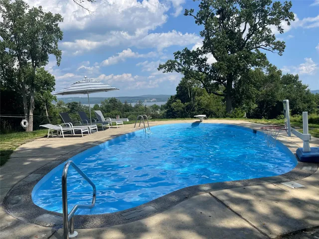 a view of outdoor space with swimming pool and furniture