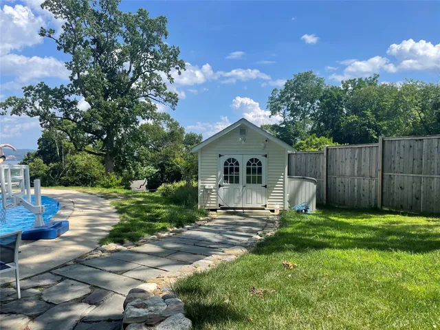 a backyard of a house with table and chairs