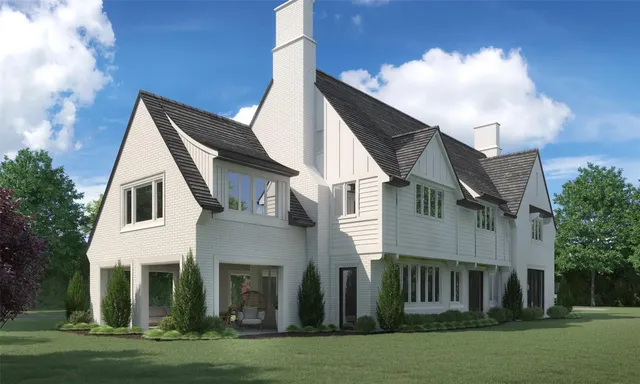 a view of a white house next to a yard