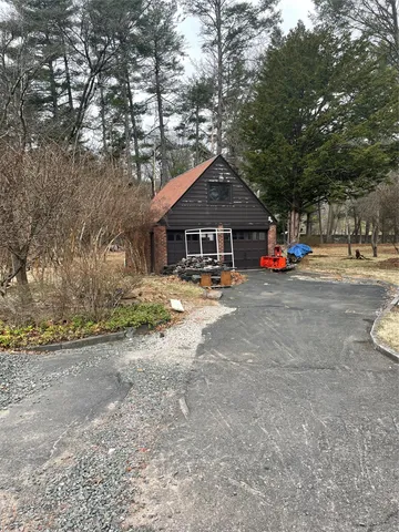 a view of a house with large space and a car parked beside it