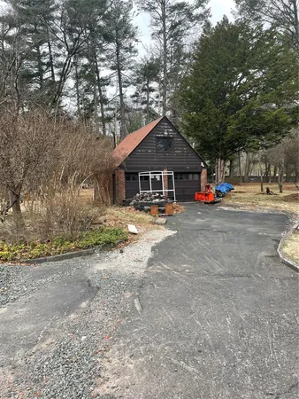 a view of a house with large space and a car parked beside it