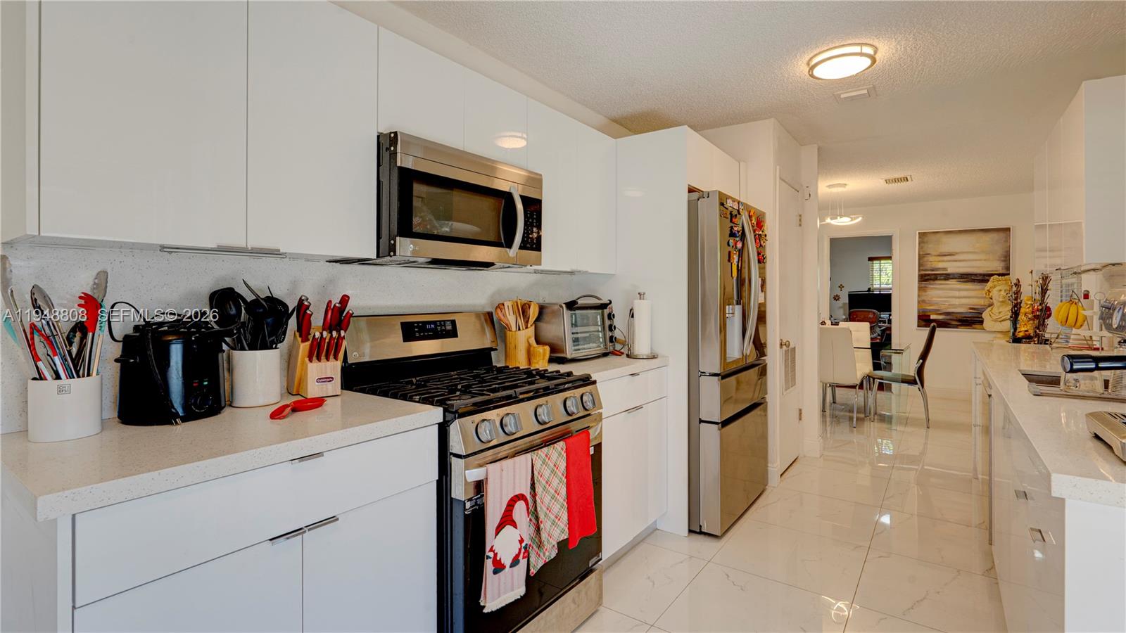 6815 Southwest 134th Court Miami, FL 33183 - Photo 12 of 53 a kitchen with stainless steel appliances granite countertop a refrigerator a stove and a sink