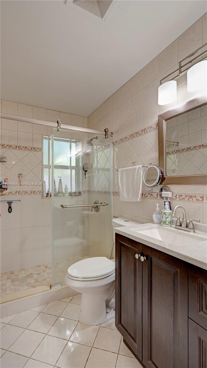 6815 Southwest 134th Court Miami, FL 33183 - Photo 17 of 53 a bathroom with a granite countertop sink toilet and shower