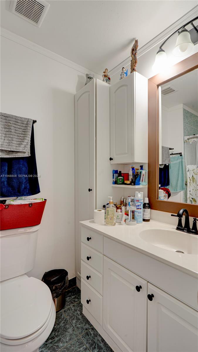 6815 Southwest 134th Court Miami, FL 33183 - Photo 31 of 53 a bathroom with a sink mirror vanity and toilet