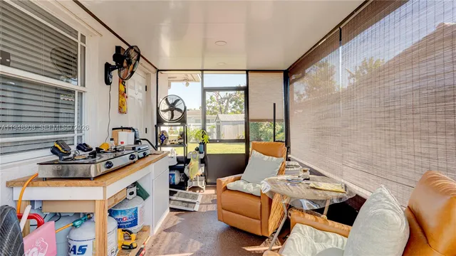 a view of a house with backyard porch and sitting area