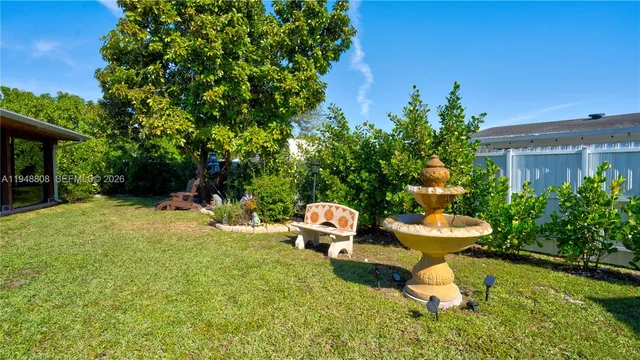 a view of a fire pit with large trees