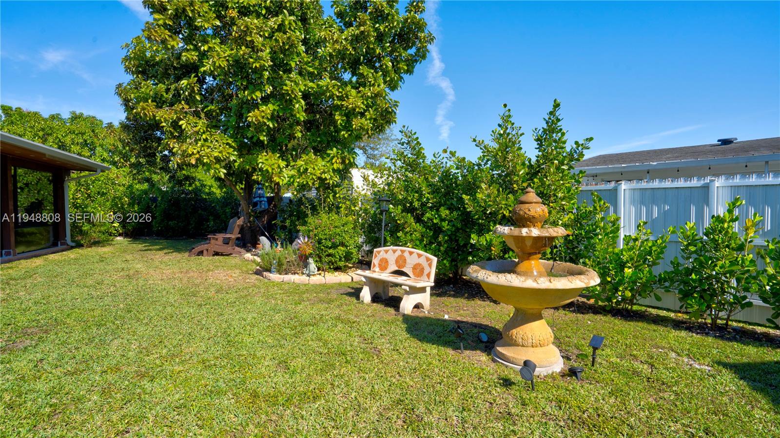 6815 Southwest 134th Court Miami, FL 33183 - Photo 38 of 53 a white bench sitting in the middle of a garden