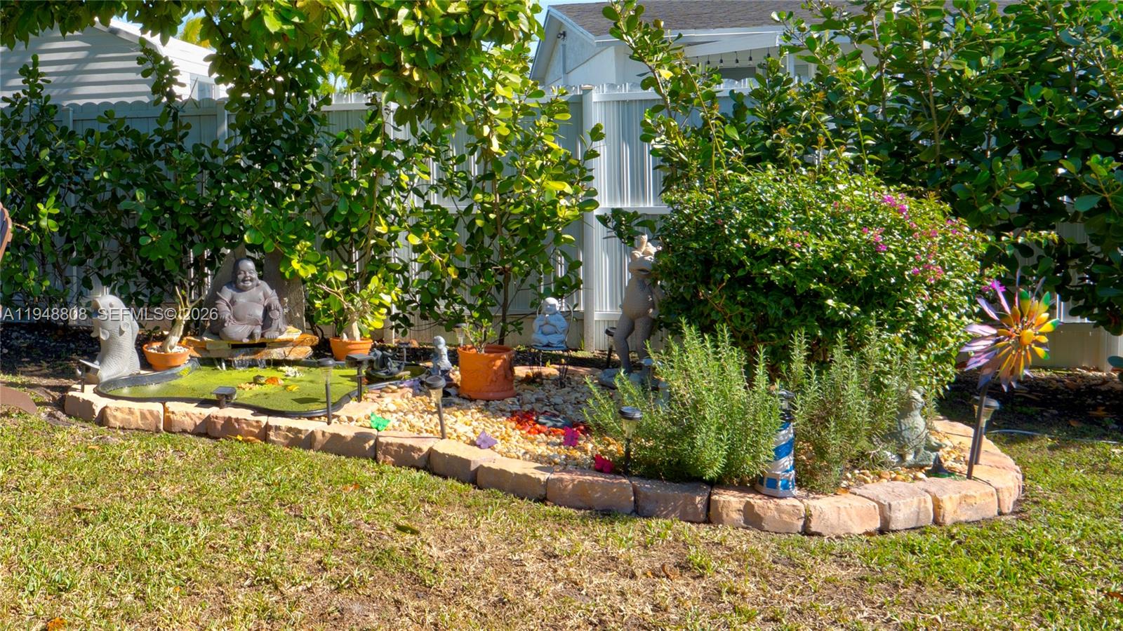 6815 Southwest 134th Court Miami, FL 33183 - Photo 40 of 53 a view of a fire pit with large trees