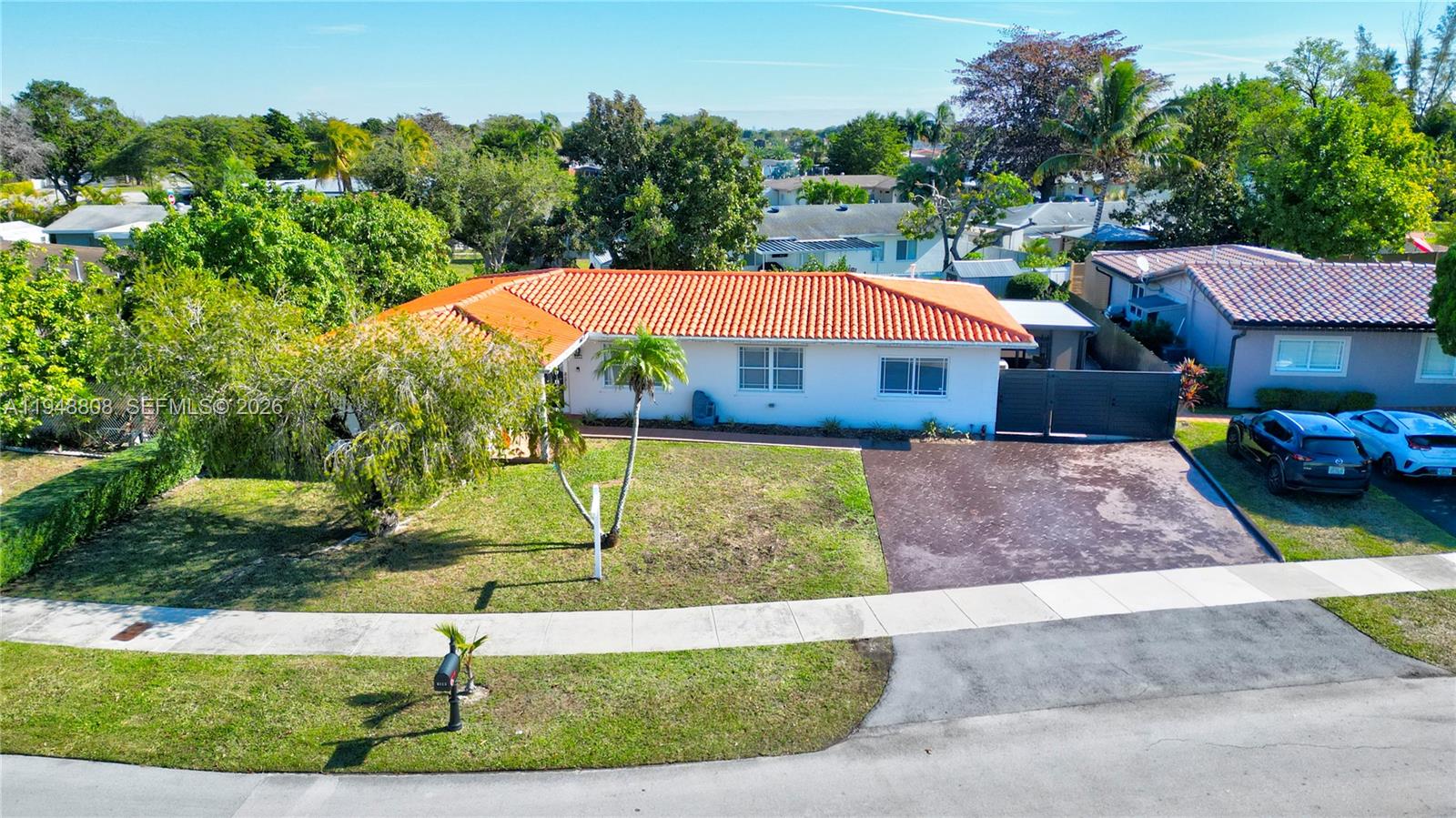 6815 Southwest 134th Court Miami, FL 33183 - Photo 5 of 53 a front view of a house with a yard and outdoor seating