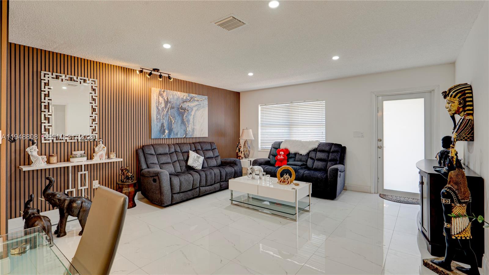 6815 Southwest 134th Court Miami, FL 33183 - Photo 8 of 53 a living room with furniture and a flat screen tv
