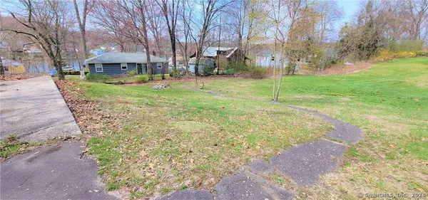 a view of a yard with a house in the background