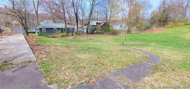 a view of a yard with a house in the background