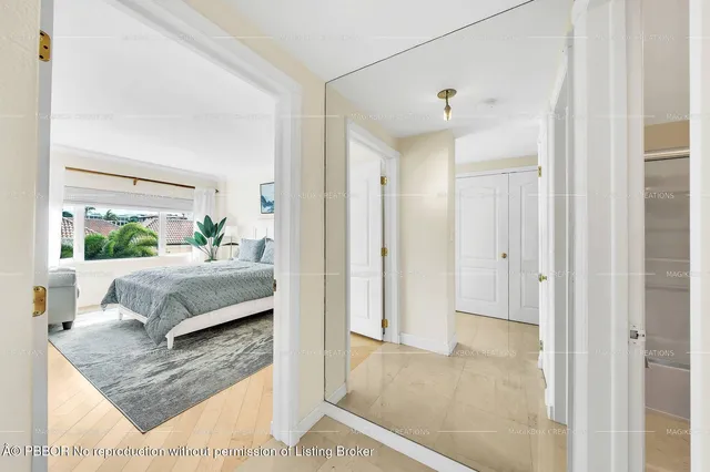 a bedroom with a bed and a potted plant