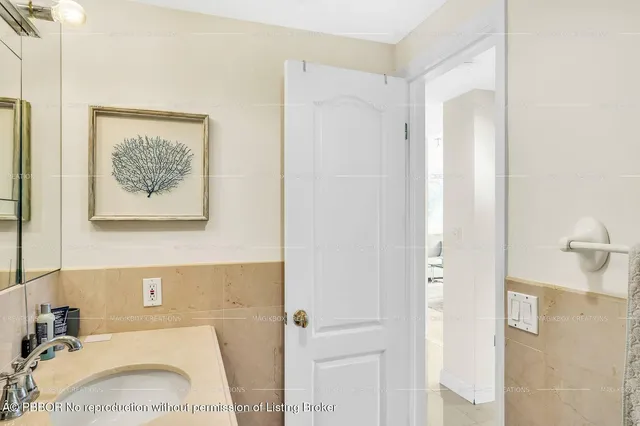 a bathroom with a sink vanity granite and shower