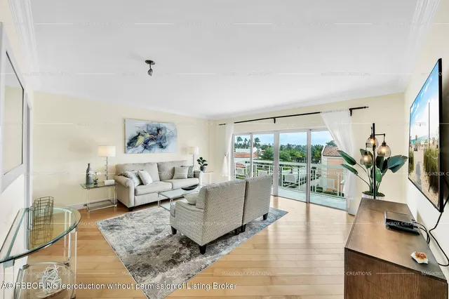 a living room with furniture a couch and a large window with outer view