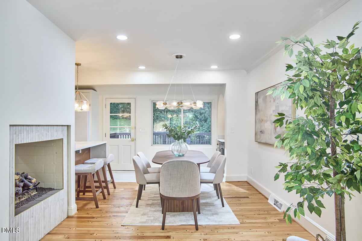 1609 Acadia Street Durham, NC 27701 - Photo 11 of 56 a dining room with furniture potted plants and wooden floor