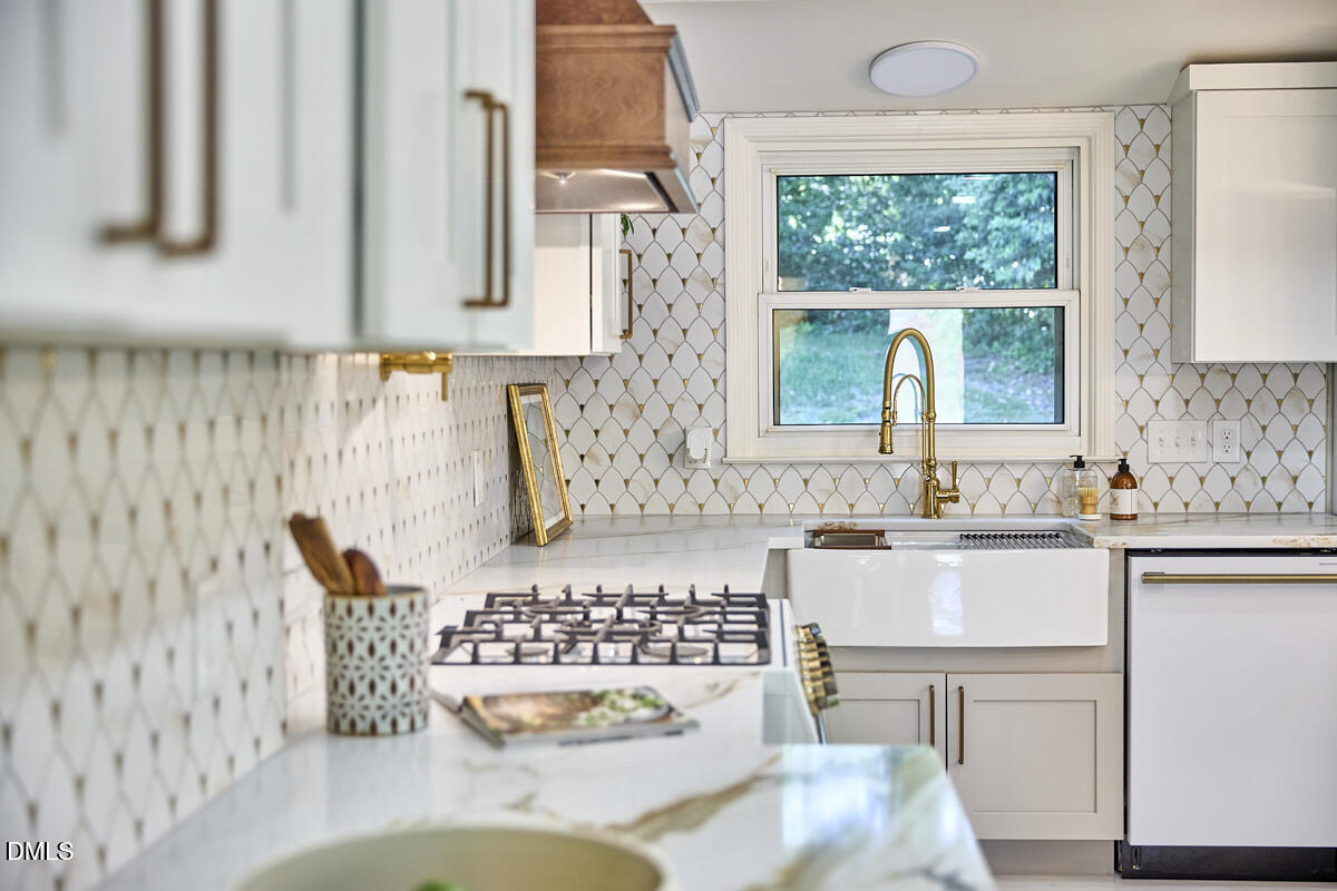 1609 Acadia Street Durham, NC 27701 - Photo 20 of 56 a kitchen with a sink and a stove next to a window