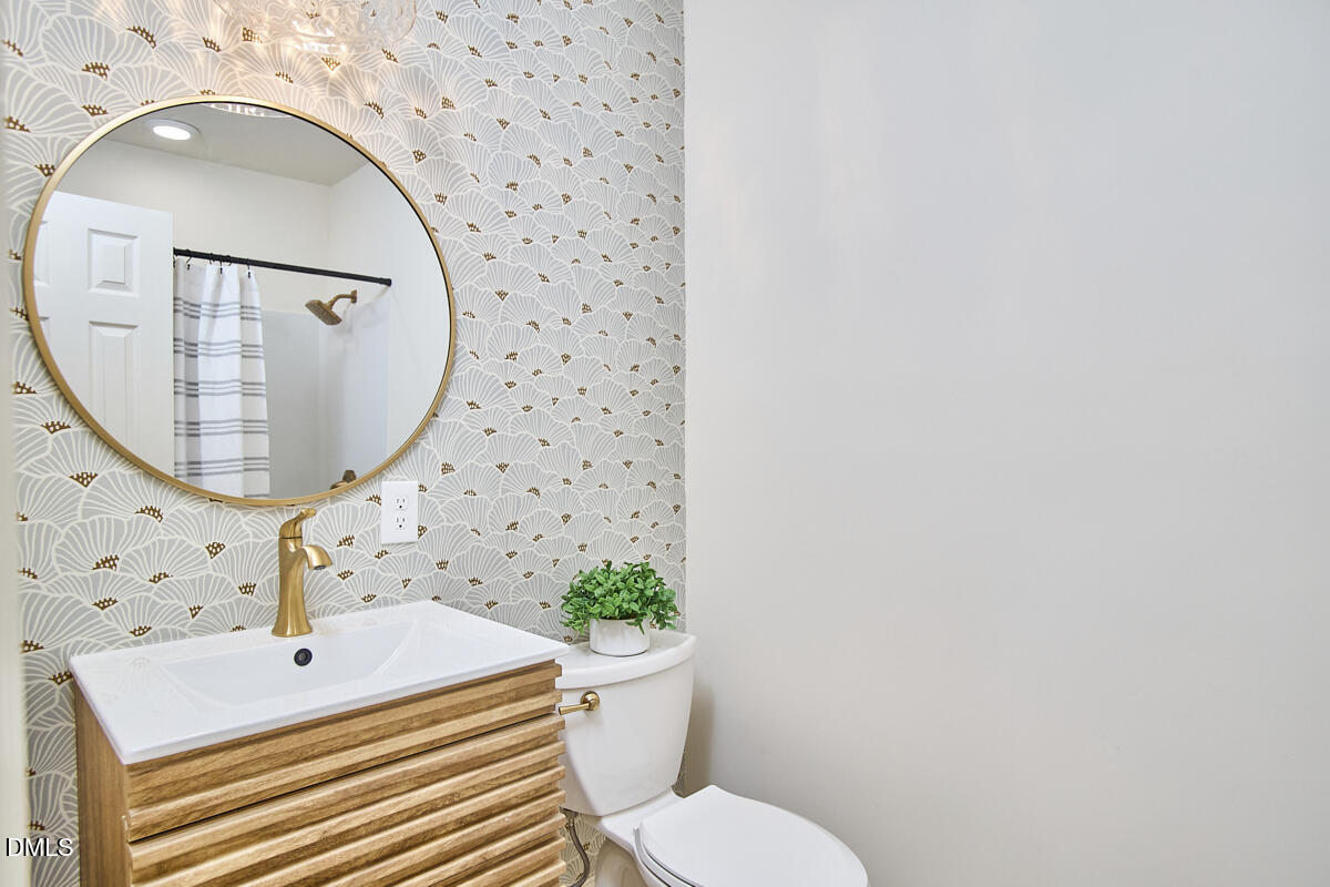 1609 Acadia Street Durham, NC 27701 - Photo 26 of 56 a bathroom with a sink mirror vanity and toilet