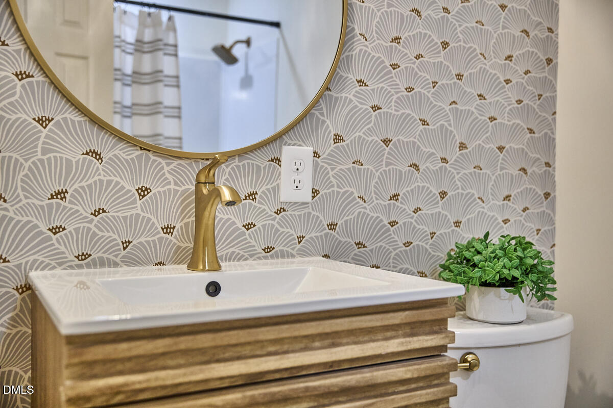 1609 Acadia Street Durham, NC 27701 - Photo 27 of 56 a bathroom with a sink and mirror with bathtub