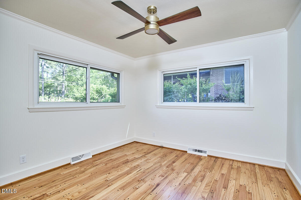 1609 Acadia Street Durham, NC 27701 - Photo 29 of 56 a view of empty room with wooden floor and fan