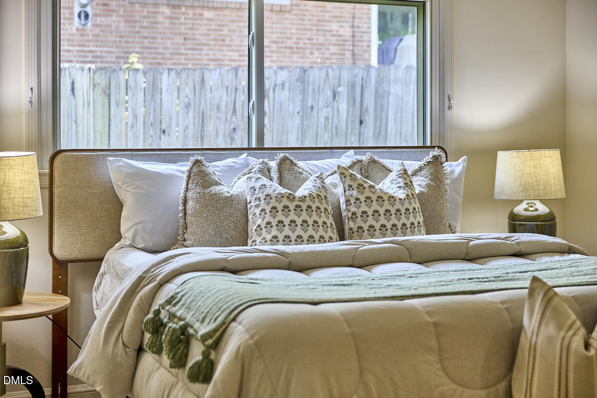 1609 Acadia Street Durham, NC 27701 - Photo 31 of 56 a bed sitting in a bedroom next to a window