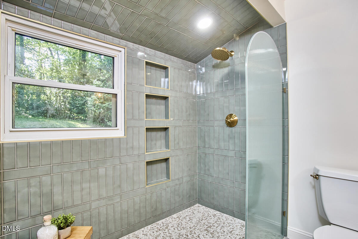 1609 Acadia Street Durham, NC 27701 - Photo 36 of 56 a bathroom with a shower and a sink